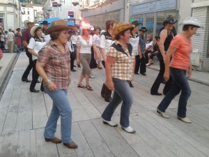 Line dancing during the Fête de la music volunteer trip.